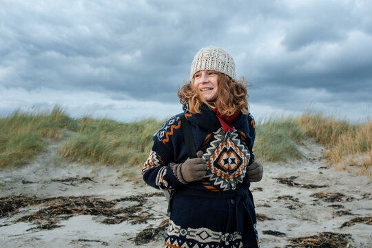 Woman enjoying the view on the Dollymount beach in Dublin, Ireland