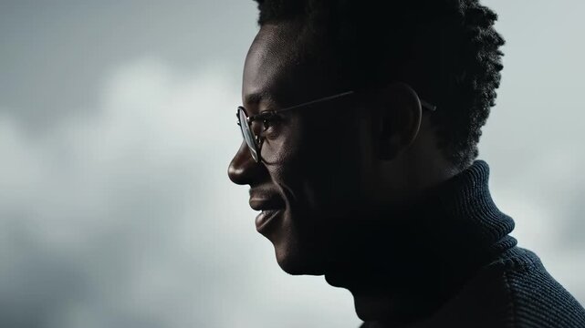 Profile of a man with glasses and a turtleneck