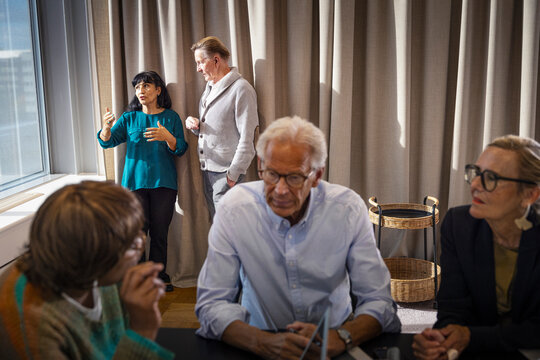 Male and female business experts in office meeting