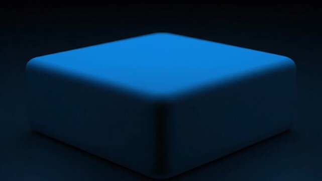 Glowing blue object undergoes transform in dark environment with smooth texture