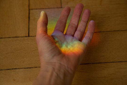 Close-up shot of hand with rainbow colors