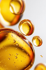 Abstract golden oil drops and bubbles creating a glossy texture, conceptualizing skincare, beauty, and health serums
