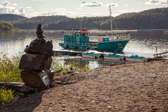 An old fishing boat is moored at the pier