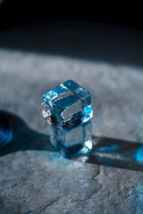 Electric blue cocktail in elegant martini glass with ice cubes and fresh lime slice. Moody dramatic lighting, sophisticated top-down view &mdash; perfect for luxury bar, party and summer refreshment concept