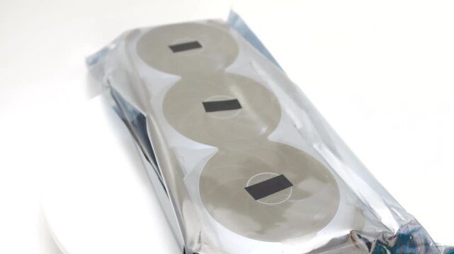 Graphics card GPU hardware rotating in protective packaging on white background for high performance gaming and workstation pc builds