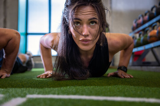 Woman doing push ups in gym