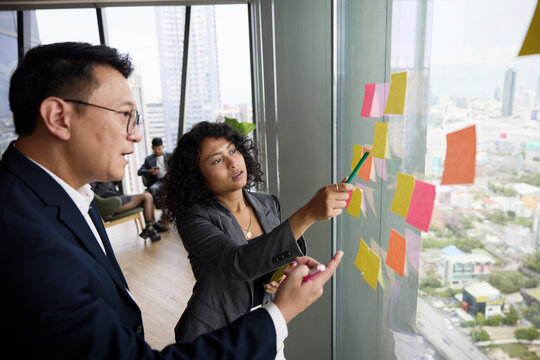 Female employee discussing strategies with manager during brainstorming session