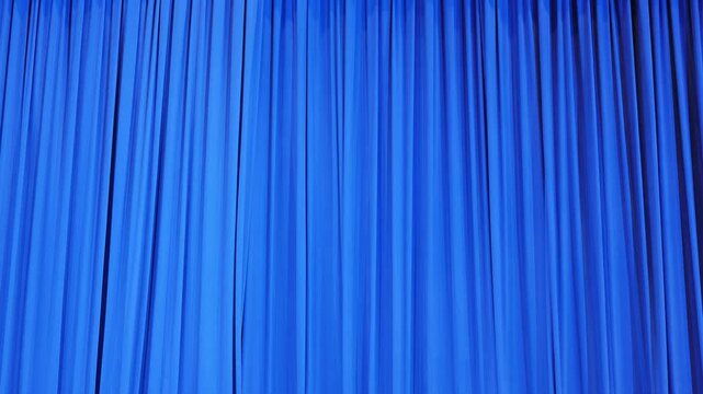 Blue theater curtain with vertical folds creating a dynamic texture backdrop