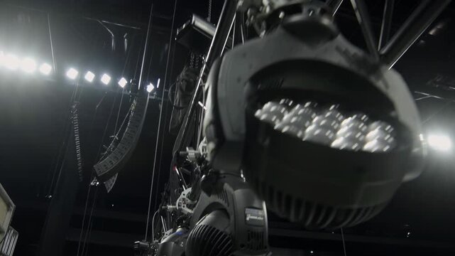 Beam frame with adjustable lighting equipment over stage closeup. Powerful spotlight lamps on support ready for installation in concert hall
