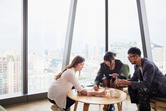 Male and female entrepreneurs planning strategies while sitting in modern office