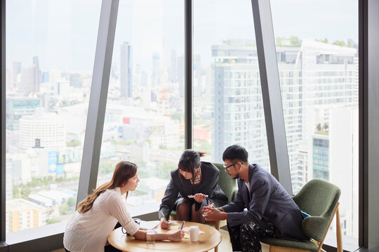 Team of corporate professionals discussing business ideas at office