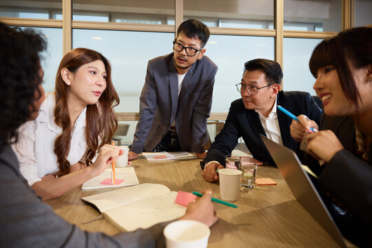 Male and female entrepreneurs sharing ideas in meeting at office