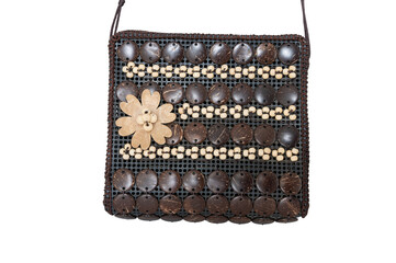 Unique small handbag with decorative wooden elements, isolated on a white background.