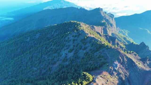 Aerial drone footage tilting up toward volcanic ridge at Roque de los Muchachos, La Palma