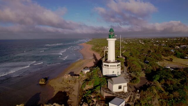 Establishing aerial, historic lighthouse overlooking the beach, Point Lonsdale