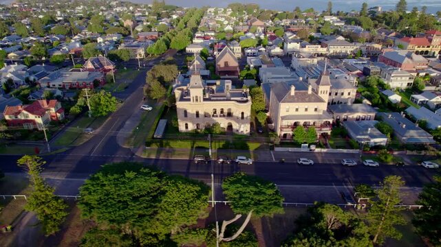 Aerial sideways tracking, Queenscliff town along Gellibrand St, sunrise
