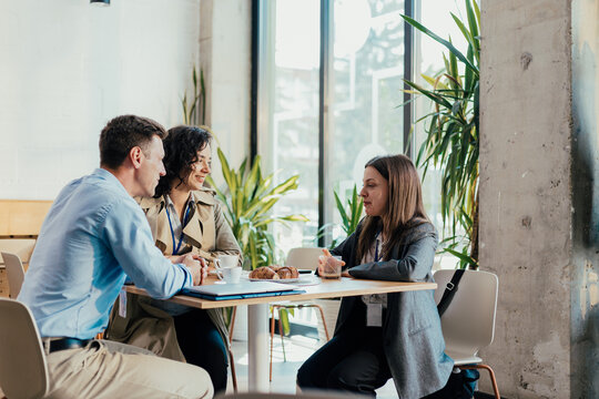 Business professionals discussing work at a coffee break