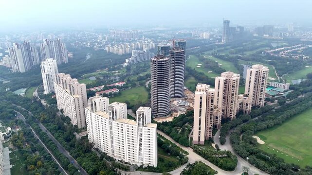 Cinematic skyline of premium high-rises, Sun Court, Jaypee Greens construction cranes, and landscaped greens highlighting rapid vertical growth in Greater Noida.