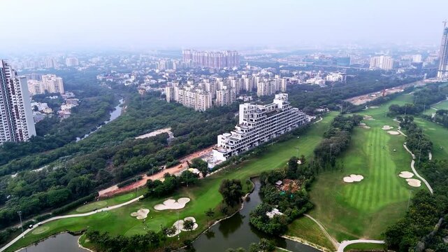 Drone footage capturing luxury towers and gated communities set amid lush fairways, showcasing Greater Noida&rsquo;s fast-growing urban landscape.