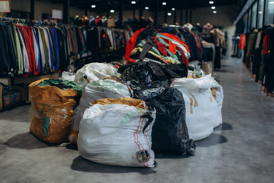 Bags of used clothing ready for sorting in an apparel thrift store