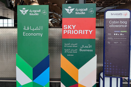 Saudia economy and Sky Priority check-in signage at Milano Malpensa Airport (MXP) in Milan, Italy on May 21, 2025