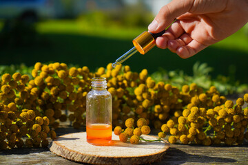 Small bottle with essential blue tansy oil (extract, tincture, infusion). Aromatherapy, spa and herbal medicine concept. © Ирина Старикова