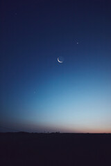 Obraz premium Morning old Moon with stars, planets and rural countryside tree silhouettes.