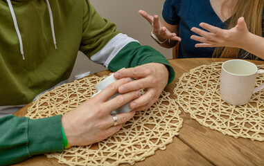 A couple chatting over hot tea at a table during lunchtime
