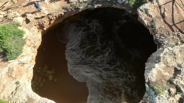 Aerial Descent into Benagil Cave Revealing Interior and Ocean Waves, Algarve
