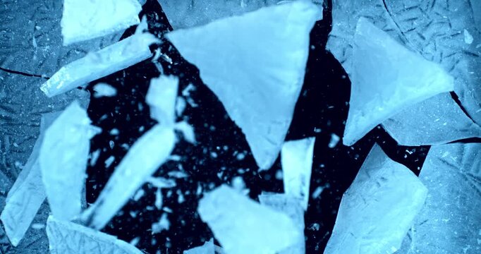 Ice explosion and shattering impact, frozen blocks breaking apart and scattering in air. Super slow motion, 1000 fps. isolated on black background. Dramatic freeze burst effect.