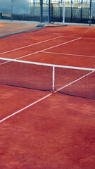Tennis court with net in middle on a sunny day at a sports facility