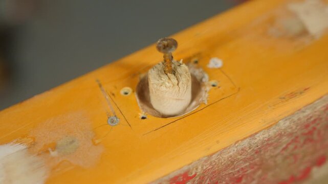 Fitting dowel into rowlock socket before fiberglass repair boat gunwale