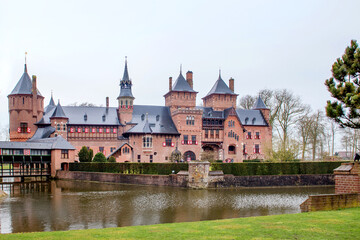 Fototapeta premium Castle de Haar, Netherlands, April 05 2018: The castles reflection in the tranquil waters of the surrounding moat, creating a serene atmosphere