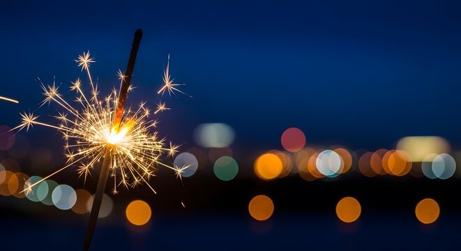 Vibrant sparkler lights illuminate nighttime celebration scene