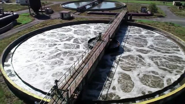 Aerial view of modern wastewater treatment plant with circular tanks