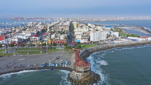 Aerial shot flying from the coast over la punta district towards the city of callao, peru