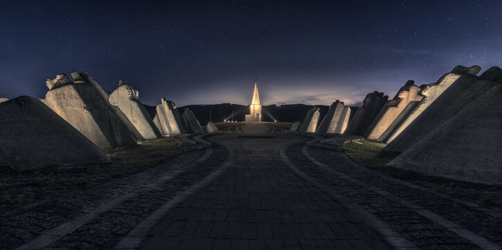 Aerial view of Kadinjaca Memorial Complex standing tall against the night sky, its stark white form a beacon of remembrance, Uzice, Zlatibor District, Serbia.