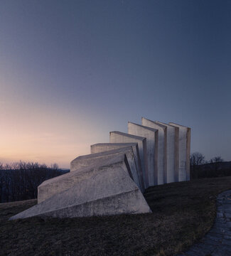 Aerial view of the stark white Partisan Memorial standing proud against the muted dawn sky, a testament to history, Uzice, Zlatibor District, Serbia.