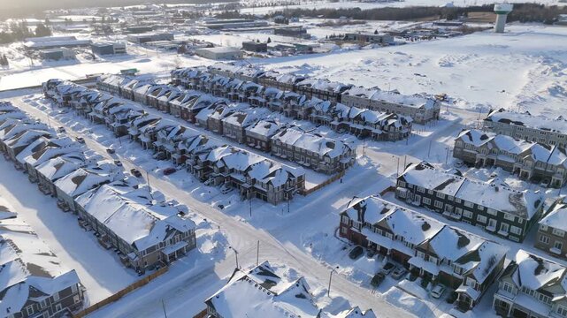 Drone footage of a newly built housing development in Erin, Ontario. Snow covered streets and modern homes illustrate residential expansion and new construction during a period of housing demand.