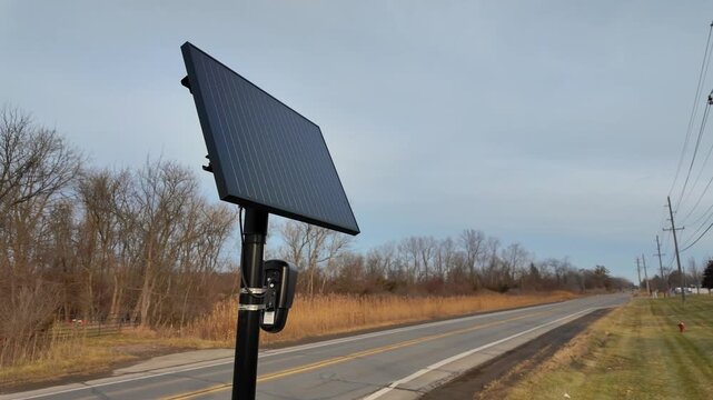 Solar-powered camera collecting traffic data along a road, providing surveillance and security. Flock camera - Monroe County, Michigan, USA