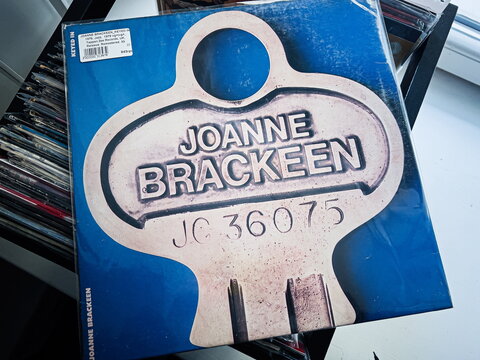 Vintage jazz Joanne Brackeen, Keyed In 1979 vinyl cover with large badge design on blue background