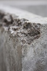 Cracked concrete surface shows signs of wear and damage in a construction site, highlighting the need for repair and maintenance in urban areas