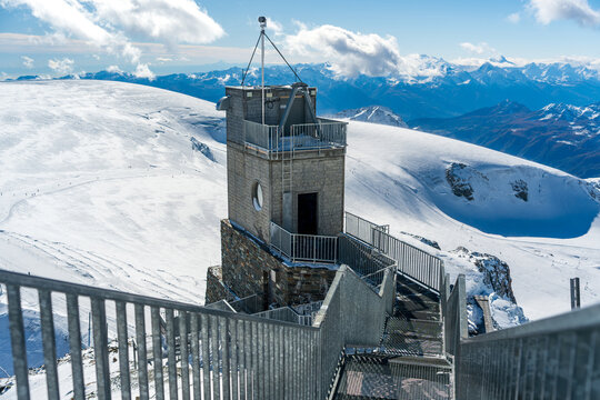 Klein Matterhorn observation deck stone elevator tower and metal stairs with sunburst. Zermatt, Canton of Valais, Switzerland. 