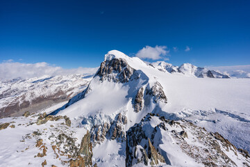 Breithorn mountain summit with massive snow cap and hanging glaciers. Zermatt, Canton of Valais, Switzerland. 
