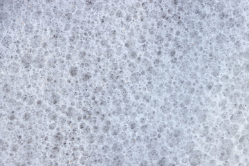 Small bubbles on surface of white sea foam