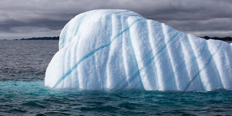 Iceberg Near Nuuk, Greenland, Cone-Shaped, With Turquoise Lines On White. © Evelyn