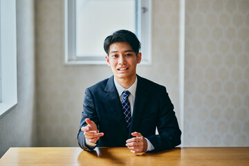 Businessman explaining during meeting or online conversation at office desk