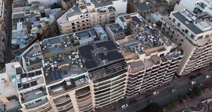 Aerial view of closely packed buildings displaying a mix of architectural styles, with cars visible on the streets below, St Julian's Bay, Sliema, Malta.