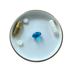 Different medical pills and supplements on saucer