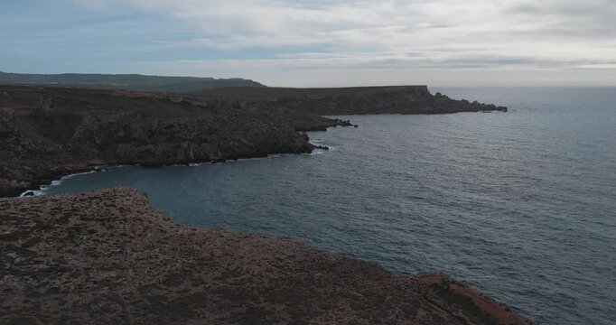 Aerial view of the rugged coastline at Ras in-Niexfa with its contrasting rocky formations and the vast expanse of the sea, Ras in-Niexfa, Mellieha, Malta.